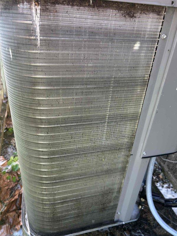 Completed scheduled Care Plan tune-up on air conditioning system with ground-level gas furnace located in crawlspace. Performed comprehensive maintenance inspection of HVAC equipment including Air-Scrubber unit mounted to ductwork system. Observed outdoor condenser coil with significant accumulation of dirt, debris, and organic matter on aluminum fins, particularly concentrated in lower and middle sections showing environmental exposure. Customer provided their own filter for replacement. System evaluated and maintained per maintenance agreement specifications, with all accessible components inspected in confined crawlspace installation.