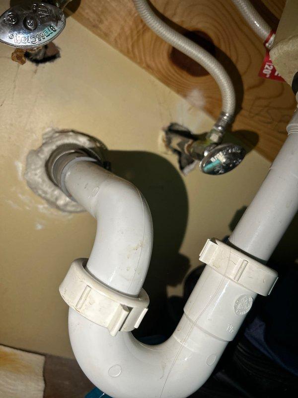 Performed routine maintenance on tanked water heater system, including complete flush to remove sediment buildup and ensure optimal performance. Inspected associated plumbing connections beneath sink, noting minor corrosion and mineral deposits on supply line fittings at shut-off valve connection points. All plumbing components, including PVC P-trap assembly, flexible braided supply lines, and drain connections, were examined and found to be in functional condition with no active leaks detected.