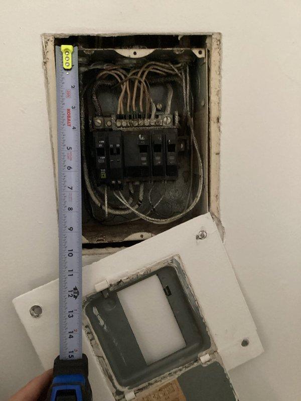 Completed electrical panel assessment for breaker repair needs. Inspected existing panel installation, documented current wiring configuration and circuit breaker arrangement, and measured panel dimensions to determine replacement or repair specifications. Panel showed signs of age with accumulated dust and requires attention to ensure safe operation and code compliance.