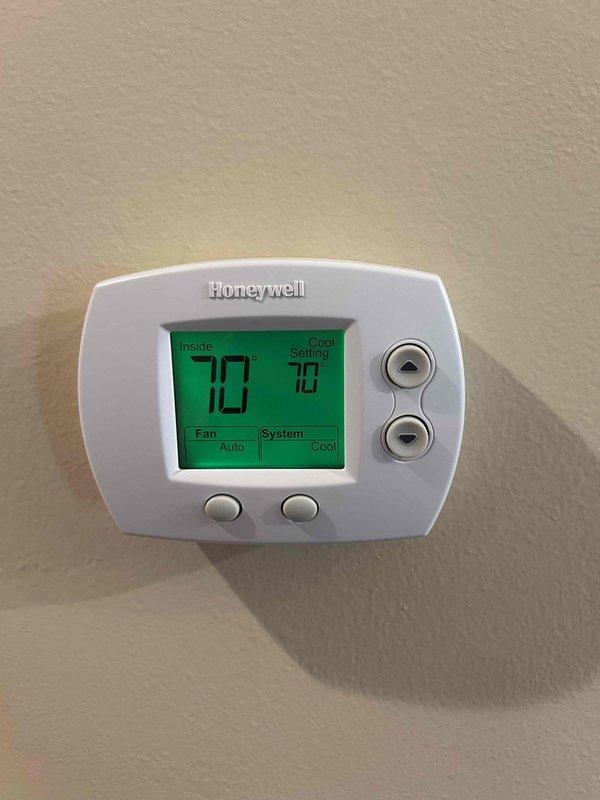 Responded to no cooling complaint on heat pump system. Upon arrival, found thermostat calling for cooling with indoor temperature at 78°F and setpoint at 70°F. Proceeded to outdoor unit for diagnostic evaluation. Discovered outdoor condensing unit contaminated with excessive debris, dried grass, and vegetation accumulated throughout electrical components and around contactor assembly. Located failed run capacitor (TITAN PRO TOCF15, 7.5µF/370V) preventing compressor operation. Removed debris from electrical compartment and surrounding components to ensure proper airflow and prevent future electrical issues. Replaced defective capacitor with new unit meeting manufacturer specifications. Verified all electrical connections secure and properly terminated. Tested system operation with compressor and condenser fan running normally. Confirmed cooling cycle engaging properly and refrigerant pressures within acceptable range. System restored to normal operation with adequate cooling capacity.