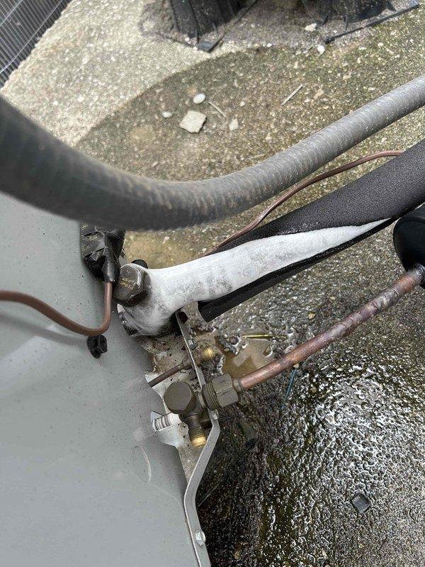 Responded to no cooling complaint at apartment complex unit. Upon arrival, performed diagnostic inspection of HVAC system including evaporator coil and rooftop condensing unit components. Inspected refrigerant lines, valve assembly, and internal air handling components. Documented equipment condition with photographs showing evaporator coil section and exterior refrigerant line connections with service valves. System evaluated for cooling capacity issues.