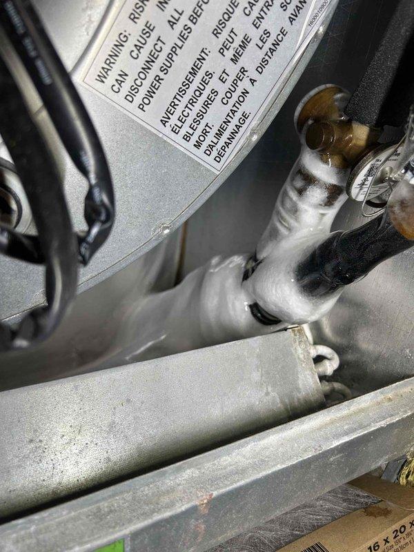 Responded to no cooling complaint at apartment complex unit. Upon inspection, found evaporator coil completely frozen with heavy ice buildup throughout. Identified restricted airflow as root cause due to severely clogged air filter. Powered down system to allow coil to thaw properly. Removed and replaced dirty filter with new filter. Inspected blower motor operation and verified proper function. Once coil fully defrosted, restarted system and confirmed adequate airflow across evaporator. Monitored system operation through complete cooling cycle. Verified proper temperature split and confirmed unit now cooling effectively. System restored to normal operation.