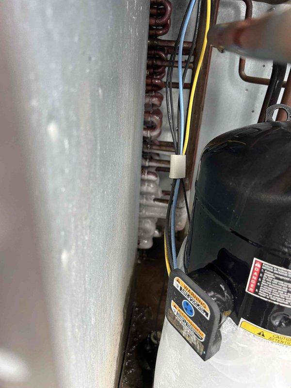 Responded to no cooling complaint on electric rooftop HVAC system blowing warm air and unable to maintain setpoint. Upon inspection, found indoor unit in utility closet with dirty evaporator coil and condensate drain pan showing significant debris accumulation and biological growth. Performed system diagnostics, cleaned evaporator coil, cleared condensate drain line, and verified proper airflow and refrigerant operation to restore cooling capacity.