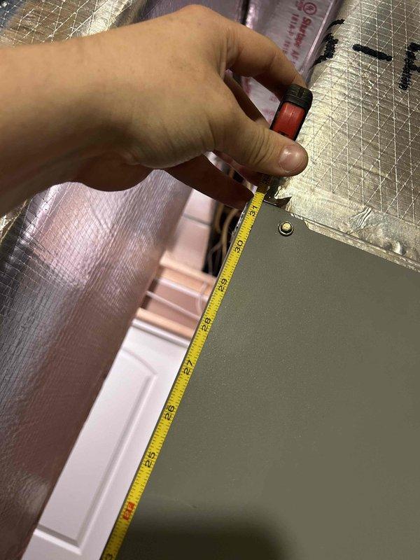 Responded to a non-cooling complaint on a 13-year-old AC unit. Upon inspection, accessed the attic space and measured existing insulation levels, which appeared inadequate based on the reflective radiant barrier material observed. Documented insulation conditions and measurements to assess potential contributing factors to the system's reduced cooling efficiency, as insufficient attic insulation can significantly impact AC performance and increase cooling loads on aging equipment.