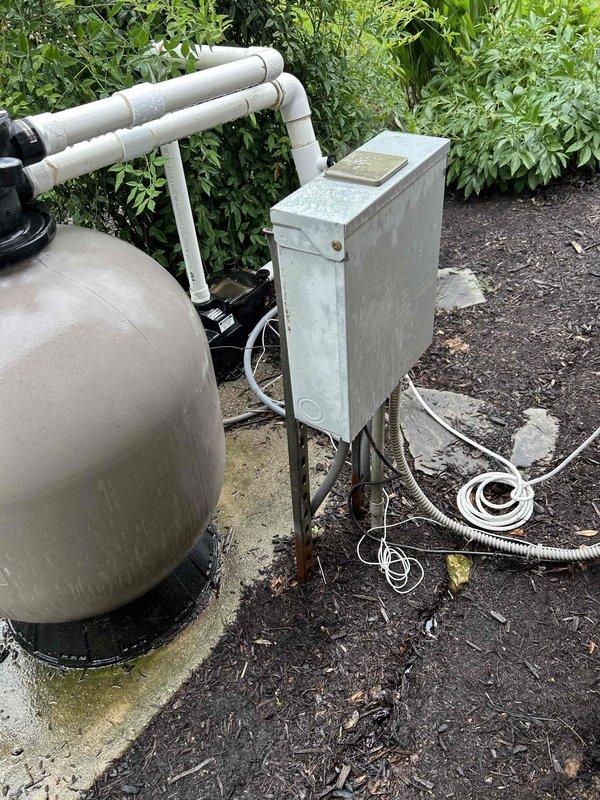Responded to pool house electrical issue where power was intermittently lost and tripping the main house breaker. Inspected the outdoor electrical panel serving the pool equipment and identified inadequate amperage capacity for the connected load, including pool pump and filter system. Evaluated the damaged interior outlet and electrical connections, documenting equipment conditions and electrical infrastructure to determine proper circuit requirements for stable operation.