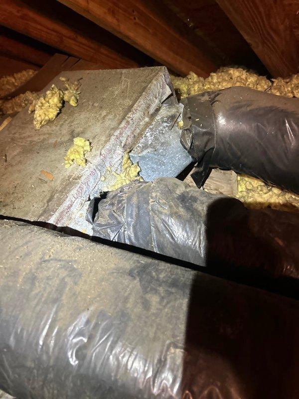 Responded to service call for water leak from attic-mounted indoor HVAC unit. Upon inspection, discovered minor water accumulation near the air handler, which had been temporarily contained with absorbent material. Performed thorough diagnostic examination of the condensate drain system, drain pan, and evaporator coil assembly. Inspected all copper refrigerant line connections and insulation for signs of condensation or moisture intrusion. Verified drain line was clear of obstructions and flowing properly. Examined flexible ductwork connections and plenum assembly for any signs of moisture damage or air leakage that could contribute to condensation issues. Documented system conditions with photographic evidence showing plumbing connections, insulation integrity, and attic installation configuration for reference.