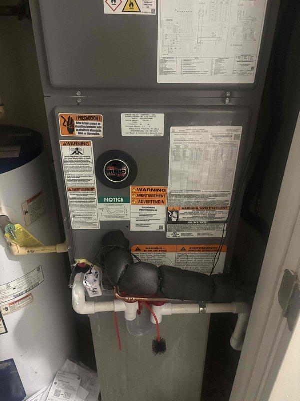 Completed full residential heat pump system installation including RUUD RP14AY24AJ2NA 15 SEER2 2-ton outdoor unit, RH2TY2417STANNJ 2-ton air handler with RXBH-1724A10J-B 10kW heat kit, and digital thermostat. Installed outdoor unit on concrete pad with snow legs, electrical disconnect box, and electrical whip kit. Applied refrigerant line insulation and installed refrigerant line filter on copper line set. Mounted air handler with transition to existing ductwork, installed drain trap with SS2 coil drain safety water sensor, and standard-sized air filter rack. Performed vacuum test to 10 microns using manifold gauge, charged system with refrigerant to manufacturer specifications, and verified proper system operation. Obtained applicable permits, removed and disposed of existing equipment, and confirmed all work meets code compliance standards. System protected under 1-year labor warranty and 10-year parts warranty.