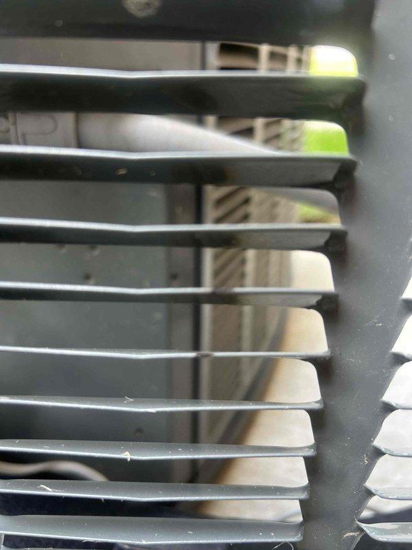 Responded to customer report of loud banging noise upon outdoor unit shutdown and progressive tinging noise during operation on a three-year-old air conditioning system. Performed diagnostic inspection of outdoor condenser unit to identify source of abnormal sounds and confirmed noise originated from customer's equipment rather than neighboring property. Inspected condenser fan assembly, compressor mounting, refrigerant lines, and internal components; documented findings with photographs of ductwork connections and exterior grille assembly for service records.