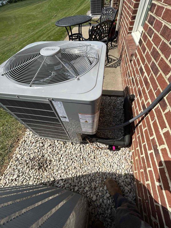 Completed residential HVAC installation of a Carrier 2-stage 18.2 SEER2 4-ton air conditioning system with matching evaporator coil. Installed AirEase model 26TPA848W003 outdoor condensing unit on new equipment pad with white gravel base adjacent to brick exterior. Basement evaporator coil model MA4821XMA installed with proper transition to existing ductwork. Installation included electrical whip kit, disconnect box, refrigerant line insulation, and filter drier. Installed SS2 coil drain safety water sensor and tested operation to verify proper function.

Replaced Air Scrubber bulb in upstairs system to restore air purification functionality. Installed T-10 thermostat with room sensor for enhanced temperature control and system efficiency.

Performed releveling service on second outdoor unit. Pumped R-410A refrigerant back into condenser, removed existing outdoor unit, prepared and leveled ground surface, installed new equipment pad with pump-up supports for proper drainage and stabili