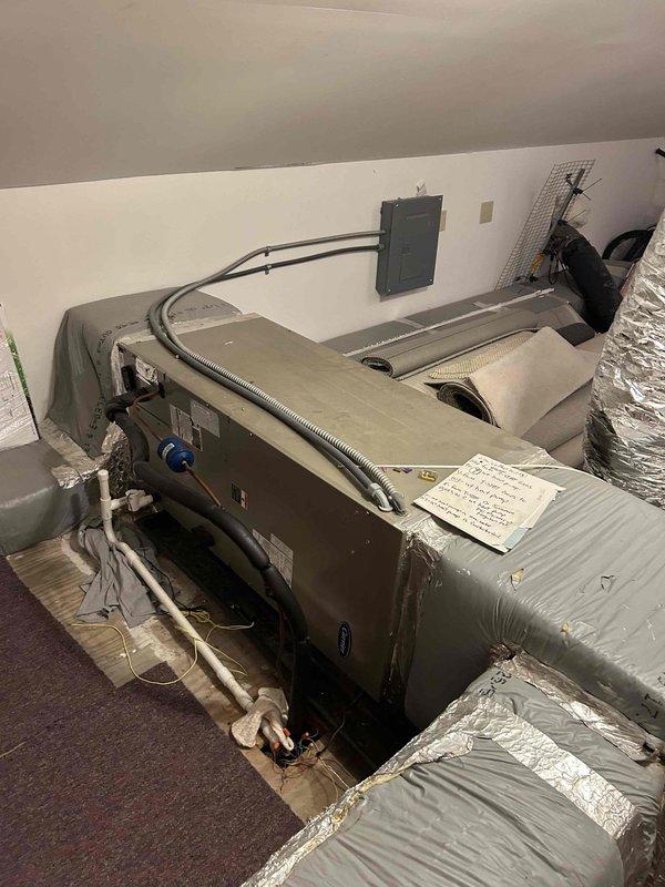 Responded to no cooling complaint on 9-year-old upstairs AC system that had run for 2-3 hours without producing cold air. Inspected air handler unit and associated components including condensate pump assembly with visible copper refrigerant lines, PVC drainage system, and ductwork. System had previous service history from approximately one month prior, indicating recurring issue requiring further diagnostic evaluation and repair to restore cooling capacity.