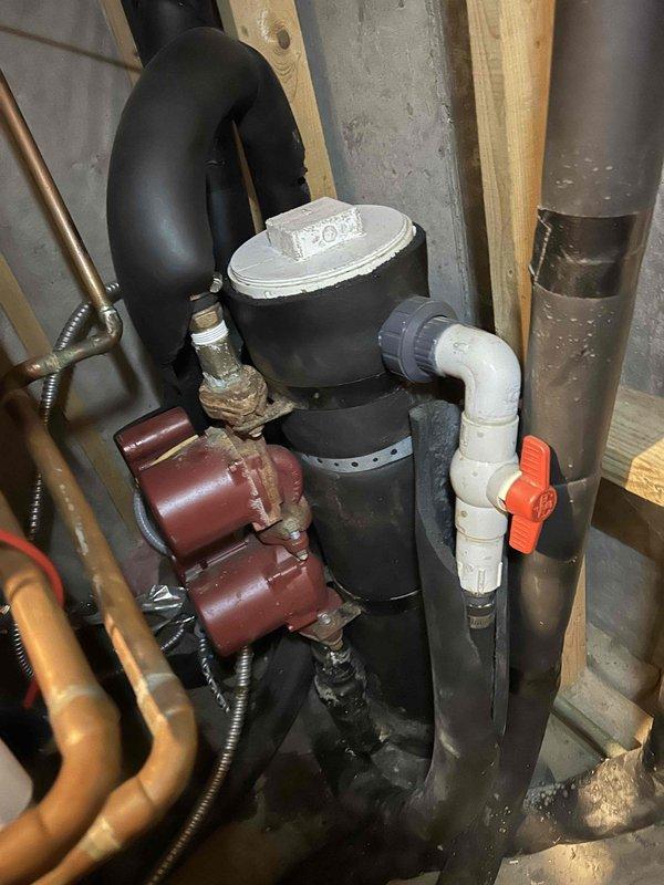 Responded to no cooling complaint on 9-year-old upstairs AC system that had run for 2-3 hours without producing cold air. Inspected air handler unit and associated components including condensate pump assembly with visible copper refrigerant lines, PVC drainage system, and ductwork. System had previous service history from approximately one month prior, indicating recurring issue requiring further diagnostic evaluation and repair to restore cooling capacity.
