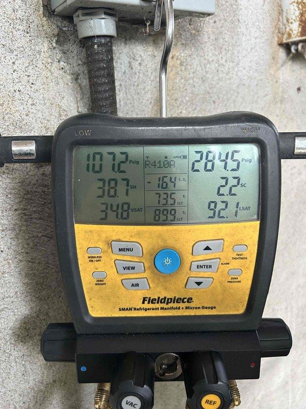 Responded to a no cooling call on a 10-year-old electric air conditioning system with indoor unit located in garage. Customer reported system blowing warm air with thermostat set to 77°F but indoor temperature reading 83°F. Upon arrival, performed complete system diagnostics using refrigerant manifold gauges and electrical testing equipment. Measured system pressures showing suction side at 107.2 PSIG and discharge side at 284.5 PSIG, indicating abnormal refrigerant pressures. Conducted electrical testing on system components to verify proper voltage and amperage readings. Identified cooling deficiency and documented system performance with diagnostic equipment readings for repair recommendations.