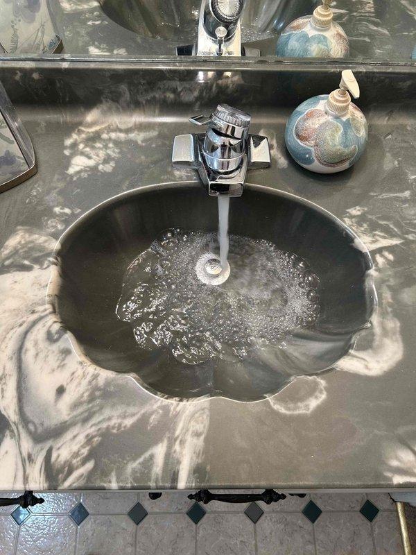 Completed routine plumbing inspection of bathroom fixtures during scheduled maintenance window. Tested water flow and drainage at decorative basin sink with chrome cross-handle faucet, verified proper operation of drain assembly, and documented fixture conditions with no issues identified requiring immediate attention.