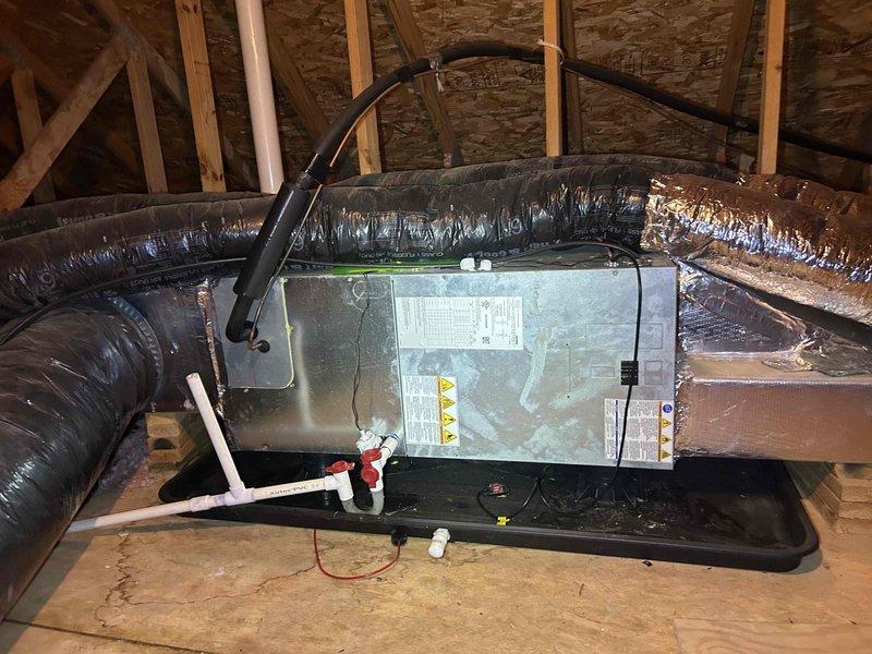 Responded to no cooling complaint on 3-year-old electric heat pump system. Accessed attic-mounted air handler unit and performed diagnostic evaluation for suspected refrigerant leak. Inspected ductwork connections, refrigerant lines, and condensate drainage system. Verified airflow from supply vents and checked system operation. Documented equipment condition and installation configuration for repair recommendations.