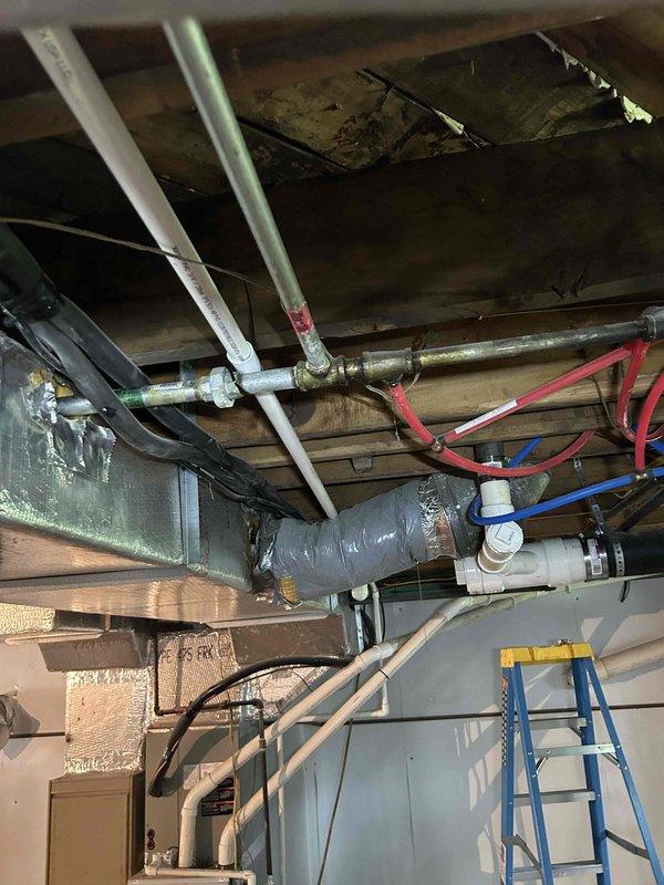 Responded to no heat call on mini split system less than 10 years old. Upon inspection, located cracked drain tubing in basement that was previously identified as running from upstairs mini split head unit down through wall cavity to condensation pump for main floor system. Repaired damaged drain line section in basement to eliminate water leakage on basement floor and restore proper condensate drainage to pump. System tested and verified operational with proper drain function restored.