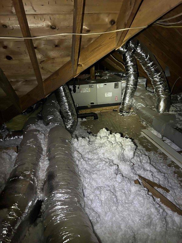 # HVAC No Cooling Diagnostic - Bryant System

Responded to service call for Bryant HVAC system experiencing inadequate cooling performance during daytime hours. Upon arrival, observed thermostat set to 75°F with room temperature reading 84°F in cooling mode, confirming insufficient cooling capacity. 

Conducted comprehensive system inspection beginning with attic-mounted air handler unit. Verified air handler operational status and examined ductwork installation throughout attic space. Inspected flexible duct connections and assessed insulation coverage on supply and return lines. Evaluated airflow from supply registers and checked for proper distribution throughout conditioned space.

Performed visual inspection of indoor unit components, checking for proper refrigerant line connections, condensate drainage, and electrical connections. Assessed blower motor operation and filter condition to rule out airflow restrictions. Documented system configuration with photos showing air handler 