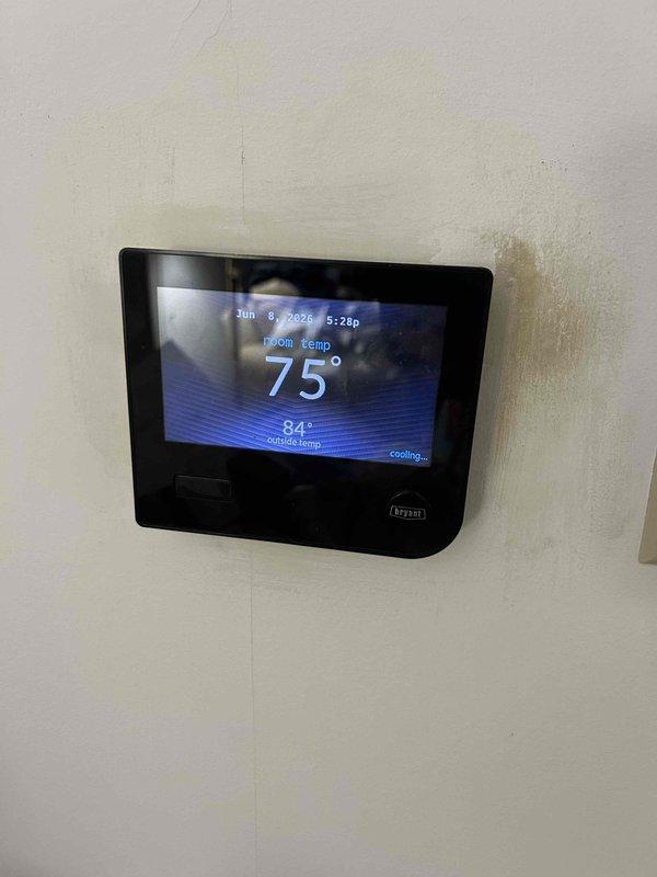 # HVAC No Cooling Diagnostic - Bryant System

Responded to service call for Bryant HVAC system experiencing inadequate cooling performance during daytime hours. Upon arrival, observed thermostat set to 75°F with room temperature reading 84°F in cooling mode, confirming insufficient cooling capacity. 

Conducted comprehensive system inspection beginning with attic-mounted air handler unit. Verified air handler operational status and examined ductwork installation throughout attic space. Inspected flexible duct connections and assessed insulation coverage on supply and return lines. Evaluated airflow from supply registers and checked for proper distribution throughout conditioned space.

Performed visual inspection of indoor unit components, checking for proper refrigerant line connections, condensate drainage, and electrical connections. Assessed blower motor operation and filter condition to rule out airflow restrictions. Documented system configuration with photos showing air handler 