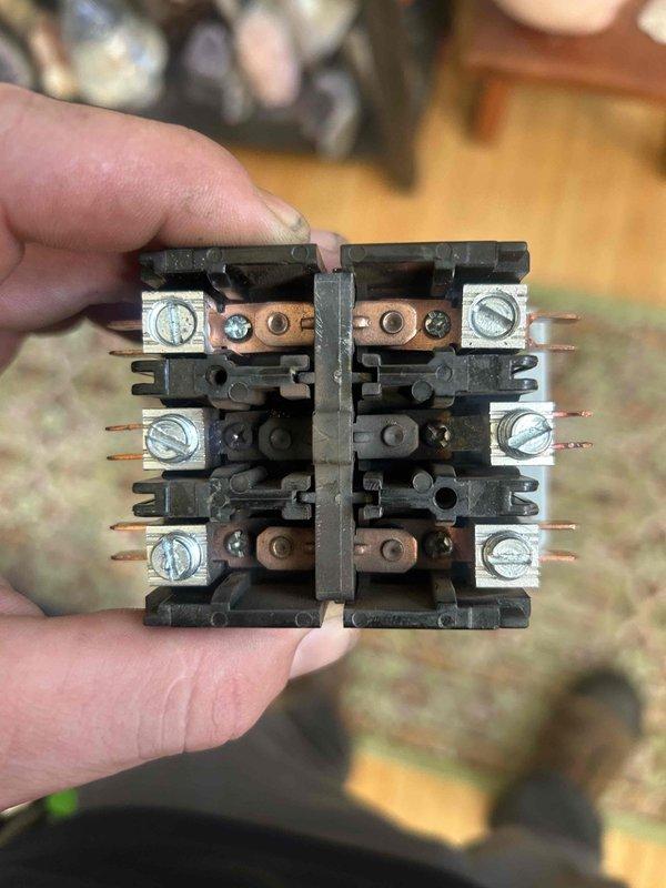 Responded to no cooling complaint on 13+ year old geothermal system blowing room temperature air with 8-degree temperature differential between setpoint and actual room temperature. Diagnosed failed contactor preventing compressor operation. Replaced defective contactor with new unit, restored proper electrical connections, and verified system operation with adequate cooling performance upon completion.