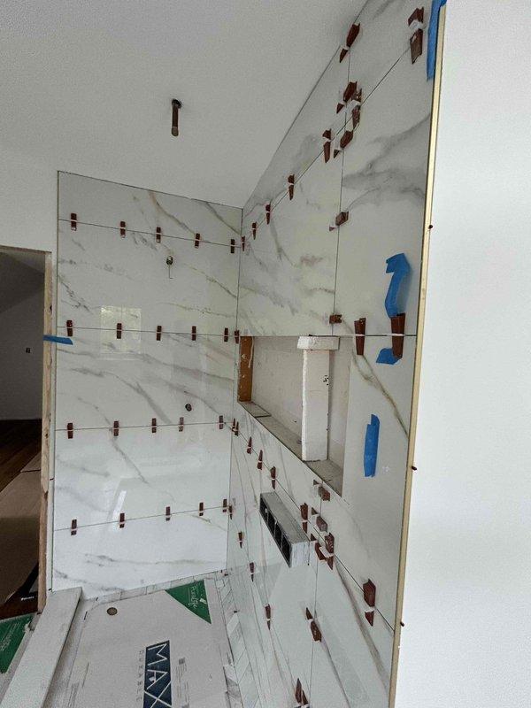 Completed electrical finish work for dormer remodel following inspection approval. Installed and terminated receptacles, switches, and wafer can lighting fixtures in renovated space with marble-tiled walls. Worked around limited attic access constraints to complete all rough-in connections and trim-out requirements.