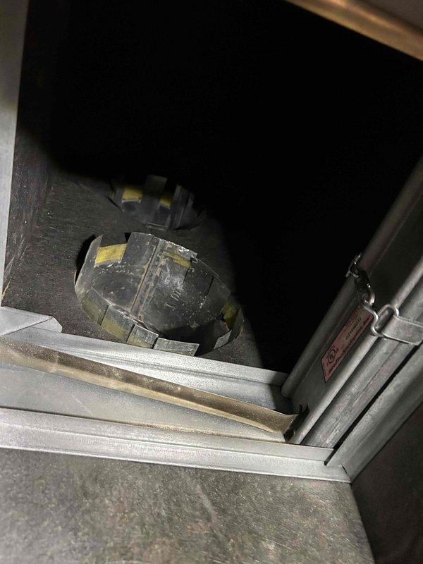 Responded to commercial no cooling call at multi-unit building. Performed diagnostic inspection of HVAC system requiring two-technician access protocol. Inspected air handling unit interior, draft inducer motors, and blower assemblies showing moderate dust accumulation. Evaluated refrigerant line connections, copper piping, insulated suction lines, and flex ductwork with tape sealing at wall penetrations. Documented equipment condition with photos for service records. System components assessed for proper operation and airflow restrictions.