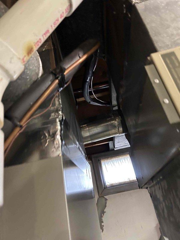 Completed Gold Level prepaid maintenance on single-system residential air conditioning unit with gas furnace and humidifier located in basement. Performed comprehensive system inspection including electrical testing with digital multimeter, confirming proper voltage readings at 239V, inspected capacitor connections and wiring integrity at junction box, and examined air handler internal components including evaporator coil, blower motor assembly, and refrigerant lines. All components found operating within normal parameters with typical dust accumulation; system functioning properly with no deficiencies noted.