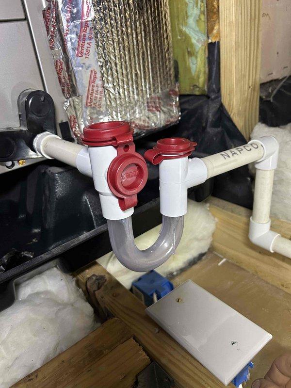 Responded to water leak complaint at indoor HVAC unit located in attic space above bonus room. Upon inspection, identified condensate drain line issue with PVC trap assembly. Found primary drain line experiencing improper drainage due to debris accumulation and potential trap seal problems. Cleared condensate drain line obstruction, verified proper pitch and flow through drain system, and tested auxiliary drain port functionality. Inspected drain pan for standing water and confirmed unit draining properly after service. Checked all connections and fittings for secure installation and proper sealing to prevent future leakage issues.