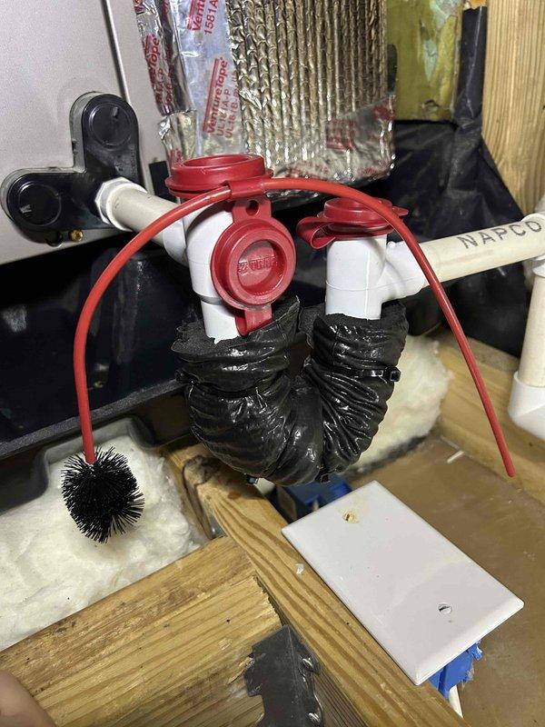 Responded to water leak complaint at indoor HVAC unit located in attic space above bonus room. Upon inspection, identified condensate drain line issue with PVC trap assembly. Found primary drain line experiencing improper drainage due to debris accumulation and potential trap seal problems. Cleared condensate drain line obstruction, verified proper pitch and flow through drain system, and tested auxiliary drain port functionality. Inspected drain pan for standing water and confirmed unit draining properly after service. Checked all connections and fittings for secure installation and proper sealing to prevent future leakage issues.