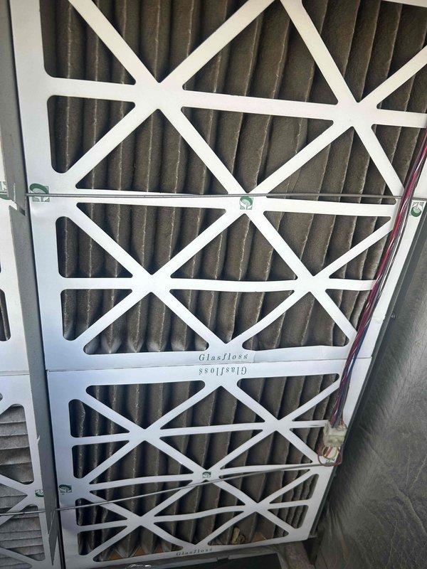 Responded to no cooling call on 3-year-old commercial AC system with drain pan filling and causing safety shutdown. Diagnosed clogged condensate drain line preventing proper drainage from secondary drain pan, triggering float switch and system lockout. Cleared blockage from drain line, verified proper drainage flow, tested float switch operation, and confirmed system returned to normal cooling operation. Inspected air filters which were found in acceptable condition.