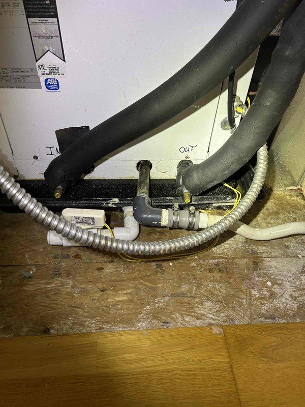 Responded to no-cooling complaint on 10+ year old geothermal system located in upstairs closet. Upon arrival, found condensate drain pan overflowing, causing unit to shut down on safety. Customer reported having to manually drain pan to restore operation. Inspected condensate drainage system and identified blockage in primary drain line preventing proper water evacuation. Cleared obstruction from drain line using appropriate tools and verified proper flow. Checked condensate pump operation and confirmed functionality. Tested system pressures with gauge to verify refrigerant charge and proper operation of geothermal loop. Monitored unit through complete cooling cycle to ensure condensate draining properly and no safety shutdowns occurring. System restored to normal operation with condensate removing as designed.