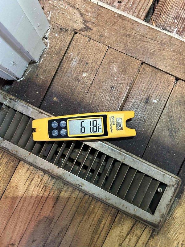 Responded to no cool complaint on 8-year-old electric system with indoor units in basement and garage. Upon arrival, thermostat set to 74°F but reading 78°F on main level, with upstairs temperatures reaching 81°F. Performed comprehensive system diagnostics including temperature measurements at supply registers, which recorded 61.8°F at floor vent indicating inadequate cooling delivery. Inspected compressor unit and refrigerant lines in attic/crawl space, noting U-shaped copper line configuration and electrical connections. Evaluated condensate drain installation and discussed relocation options to address winter freezing issues and summer dripping onto garage floor. Assessed ductwork system and airflow distribution to identify factors contributing to inadequate temperature maintenance and differential between floors. Provided findings on system performance, duct design considerations, and recommendations for resolving temperature imbalances throughout the home.