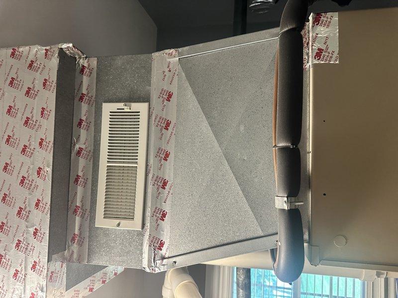 Completed estimate for full HVAC system replacement on 25-year-old air conditioning unit with indoor air handler located in laundry room. Assessed existing grey metal air handler with flexible black ductwork and outdoor condensing unit with beige top housing positioned on composite decking against exterior wall. Customer requested ASAP replacement with no brand preference and will not require financing options.