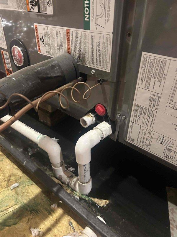 Responded to callback for system not operating. Upon arrival, found the condensate drain line clogged again, causing the float safety switch to trip and shut down the air handler. Removed accumulated debris and buildup from the drain line using vacuum equipment. Cleared the P-trap assembly and verified proper drainage flow through the PVC condensate system. Tested the red-mounted safety switch for proper operation. Cycled the system and confirmed normal startup with no fault conditions. System operating as designed at time of departure.