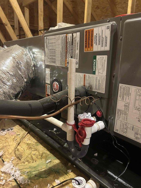 Responded to callback for system not operating. Upon arrival, found the condensate drain line clogged again, causing the float safety switch to trip and shut down the air handler. Removed accumulated debris and buildup from the drain line using vacuum equipment. Cleared the P-trap assembly and verified proper drainage flow through the PVC condensate system. Tested the red-mounted safety switch for proper operation. Cycled the system and confirmed normal startup with no fault conditions. System operating as designed at time of departure.