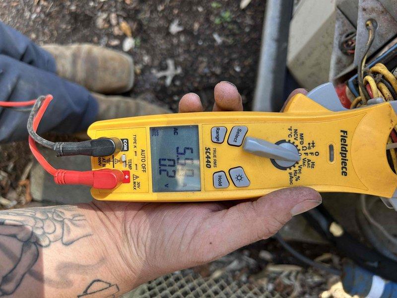 Responded to no-cool call for third-floor AC system with indoor temperature at 93°F. Performed electrical diagnostics using multimeter to test voltage and amperage at outdoor unit. Identified failed capacitor preventing compressor operation, evidenced by low voltage readings and visual inspection of deteriorated component near condenser coil with accumulated debris.