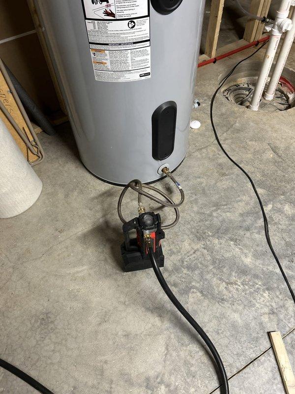 Performed routine maintenance flush on AO Smith heat pump water heater less than 2 years old per BNI referral. Drained sediment from tank, inspected pressure relief valve operation, verified all shut-off valves and copper connections for proper function, and confirmed heat pump unit operational status upon completion.