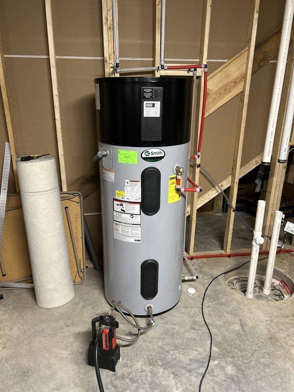 Performed routine maintenance flush on AO Smith heat pump water heater less than 2 years old per BNI referral. Drained sediment from tank, inspected pressure relief valve operation, verified all shut-off valves and copper connections for proper function, and confirmed heat pump unit operational status upon completion.