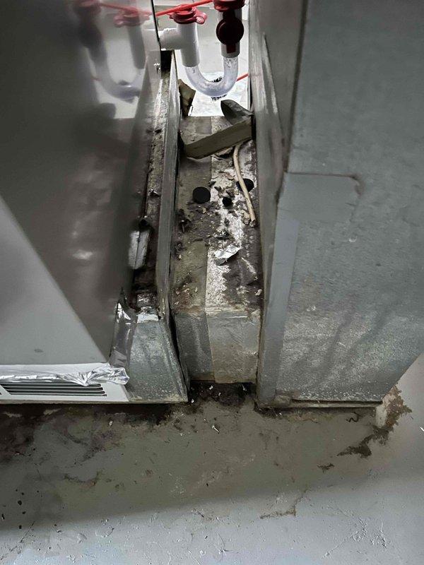 Responded to warranty call for recently installed HVAC system experiencing freezing, water leakage, and loss of cooling capacity with indoor temperature reaching 80 degrees. Upon inspection, discovered severely corroded condensate drain pan with significant rust, mineral deposits, and water damage indicating drainage system failure. Performed diagnostic testing using digital instrumentation to assess system performance and identify root cause of cooling failure. Documented extensive deterioration of drain pan components and evidence of ongoing water accumulation causing system malfunction. Given the critical nature of the situation and compromised condition of drainage components, recommended immediate corrective action to restore proper system operation and prevent further water damage.