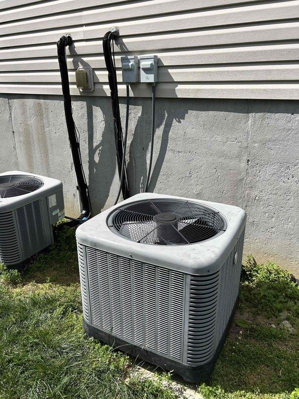 Responded to no cooling complaint on approximately 10-year-old electric air conditioning system where downstairs indoor air handler was running but outdoor condenser unit failed to operate. Performed diagnostic evaluation of split system including visual inspection of outdoor condenser unit and indoor air handler equipment. Troubleshot electrical circuit, checked disconnect box operation, and tested control voltage between indoor and outdoor units to isolate communication failure preventing compressor operation.