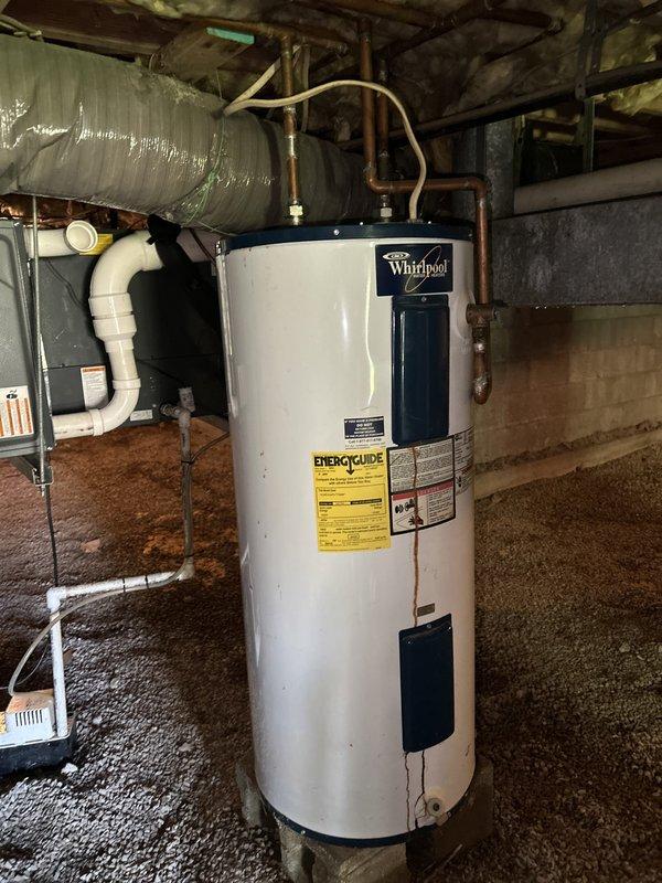 Conducted on-site assessment of leaking water heater in basement crawl space. Inspected existing Whirlpool residential water heater unit, documented copper supply line connections, PVC discharge piping configuration, and identified source of leak requiring replacement. Evaluated customer's request for hose spigot relocation work and provided comprehensive estimate for water heater replacement and plumbing modifications.