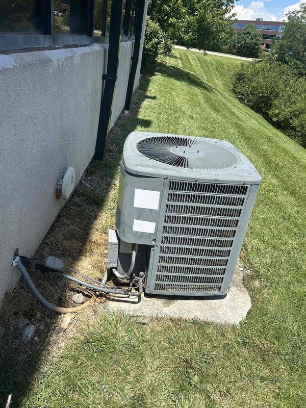 Responded to no cooling complaint for 12+ year old commercial HVAC system serving front desk and lobby area. Performed diagnostic evaluation of outdoor condensing unit and indoor air handler located in basement. System had previous capacitor replacement in April but continued to struggle maintaining adequate cooling. Conducted comprehensive inspection of both outdoor and indoor components, checked refrigerant levels, examined electrical connections, and assessed overall system performance. Documented equipment condition with photographs and gathered manufacturer specifications and model information for potential system replacement recommendation due to age and declining performance of existing unit.