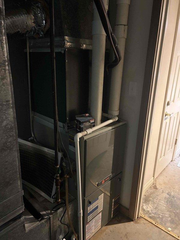 Responded to no cooling complaint for 12+ year old commercial HVAC system serving front desk and lobby area. Performed diagnostic evaluation of outdoor condensing unit and indoor air handler located in basement. System had previous capacitor replacement in April but continued to struggle maintaining adequate cooling. Conducted comprehensive inspection of both outdoor and indoor components, checked refrigerant levels, examined electrical connections, and assessed overall system performance. Documented equipment condition with photographs and gathered manufacturer specifications and model information for potential system replacement recommendation due to age and declining performance of existing unit.