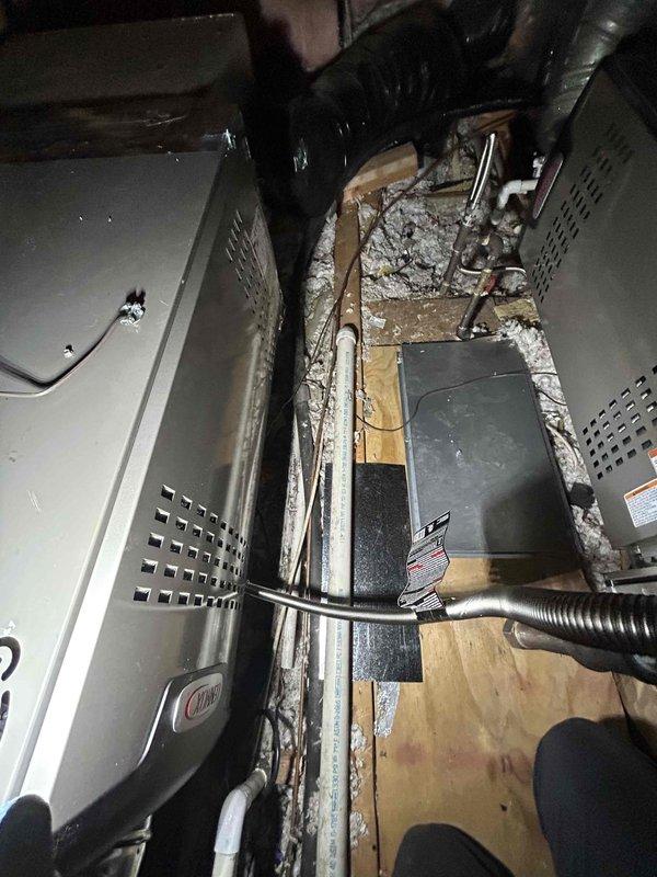 Completed full HVAC system replacement including installation of two Lennox 3-ton 2-stage air conditioning units with corresponding 80% efficiency 2-stage furnaces (Model EL280UH070E36AK), two evaporator coils (Model ML17KC2-024-2302), and two digital thermostats. Installed outdoor unit pads, electrical whip kits, disconnect boxes, refrigerant line insulation, and filter driers for both systems. Connected evaporator coils to existing ductwork with proper transitions and installed standard air filter racks. Completed all gas connections using flexible gas line connectors with shut-off valves and flame rollout protection devices. Reconnected and secured vent piping from furnaces through roof penetrations. Installed electrical shut-off switches for both systems and wired all components to code. Added SS2 coil drain safety water sensors to both evaporator coils for overflow protection. Constructed new walkway in attic space to furnace locations to stabilize flooring and provide safe access