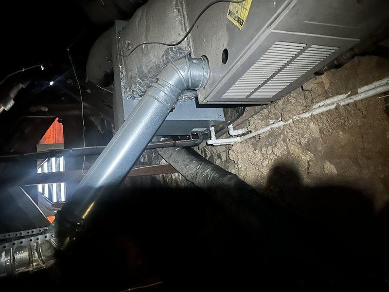 Conducted comprehensive estimate for complete HVAC system replacement of two existing gas furnace and air conditioning units, both approximately 20 years old and at end of serviceable life. Primary unit located in attic space and secondary unit in crawlspace, both requiring ladder access for evaluation. Inspected existing ductwork infrastructure in crawlspace, noting galvanized steel plenum connections and supply ductwork with metallic elbow transitions. Evaluated current system configuration including return air grilles, electrical wiring, and distribution components throughout both zones. Documented foundation-mounted equipment locations and existing duct sealing conditions. Customer requested immediate replacement timeline with specific exclusion of certain manufacturer brands from proposal options, with interest in financing solutions for dual-system replacement project.