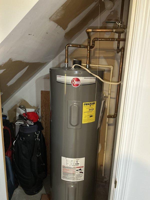 Completed comprehensive plumbing inspection as part of preventative service agreement (PSA). Inspected Rheem Professional series water heater installation in attic space, including copper piping connections, shut-off valves, and overall system condition. All components found to be functioning properly with no leaks or deficiencies noted; documented installation with photographs for service records.