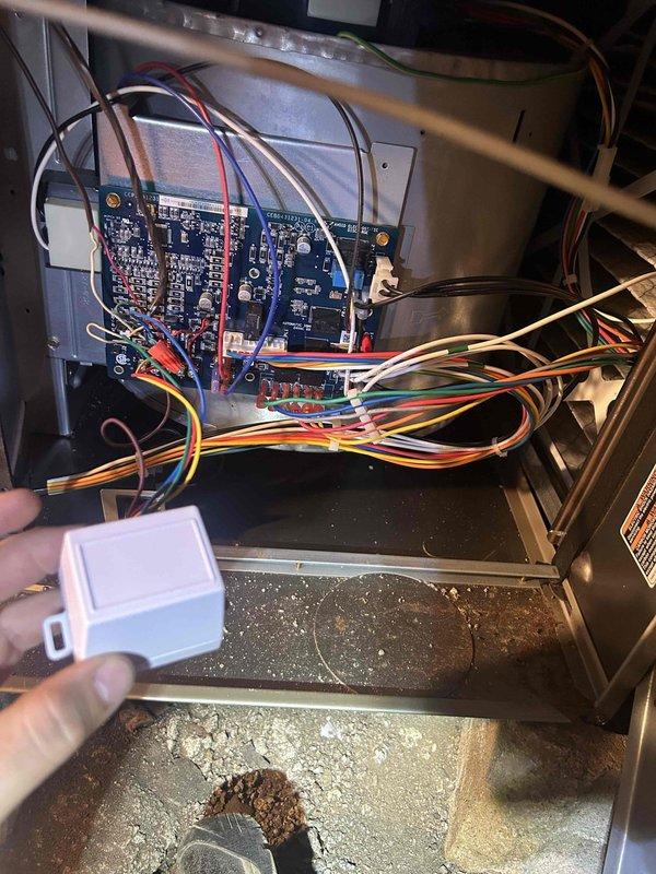 Responded to no-cool call on 10-year-old AC system with blower motor failure in crawlspace air handler. Upon inspection, found blower motor not operating in automatic mode as reported. Diagnosed faulty blower motor relay on control board preventing motor engagement when thermostat called for cooling. Observed significant debris accumulation in unit base including dust, dirt, and insulation fragments that could impact system performance. Verified thermostat communication and settings showing system in auto mode with fan-on configuration at time of service. Documented control board wiring connections and internal component condition for repair recommendations.