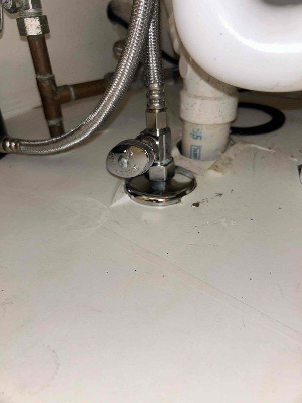 Responded to leak under kitchen sink in 38-year-old home. Upon inspection, identified cracked PVC drain pipe beneath the double-basin kitchen sink as the source of the leak that had been active for 2-3 days. Replaced the damaged PVC drain section and installed two new chrome escutcheon plates (decorative covers) at the supply line connections to restore proper appearance and function. Verified all connections were secure with no active leaks, tested water flow through both basins, and confirmed proper drainage operation before completing the service call.