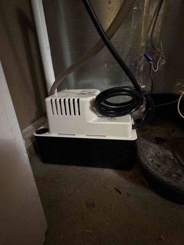 Completed full system replacement involving removal and disposal of existing HVAC equipment. Installed new Trane 14.3 SEER2 3-ton heat pump system (model 5TWR4036A1000A) with matching air handler (model 5TEM4B04AC31S) and 15KW heat kit (model ABAYHTR1517BRKA). Outdoor unit mounted on new equipment pad with snow legs for elevation and proper drainage. Installed electrical disconnect box and whip kit to code specifications. Ran new refrigerant line set with insulation and inline filter dryer between outdoor condenser and indoor air handler.

Indoor air handler installation included integration with existing ductwork using custom transitions. Installed condensate drain system with P-trap, SS2 coil drain safety sensor, and ceiling saver overflow drain pan equipped with secondary water sensor for leak protection. Added condensate pump to manage drainage. Mounted standard-sized air filter rack for easy filter maintenance access.

Completed all electrical connections including power supply to