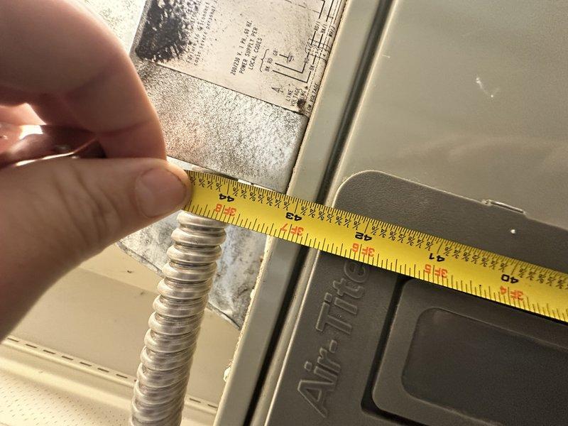 Conducted comprehensive HVAC system evaluation for equipment replacement estimate. Assessed existing indoor unit configuration, measured clearances and dimensions at connection points including flexible conduit junctions, and documented electrical panel specifications with circuit breaker arrangement to determine compatibility requirements for new system installation.