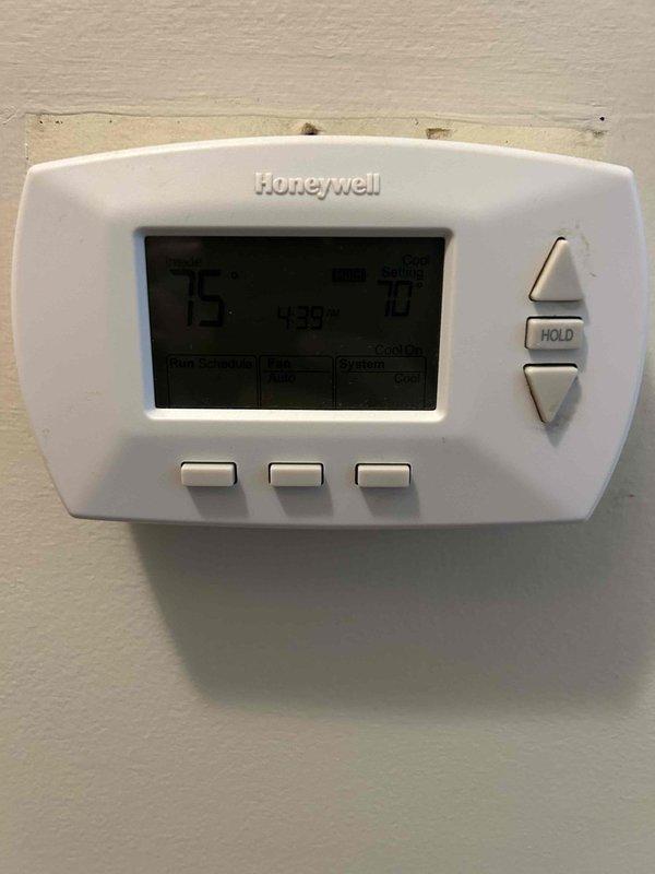 Responded to non-urgent service call for 15-year-old Carrier central air conditioning unit with outdoor fan motor failure. Outdoor fan was not spinning but could be manually rotated, indicating motor capacitor or motor failure rather than seized bearings. Verified indoor airflow and cooling operation at thermostat, confirmed system producing cool air despite outdoor fan malfunction. Performed diagnostic testing including visual inspection of outdoor unit, measured supply air temperature at register, and assessed overall system performance to determine outdoor fan motor required replacement to restore proper condenser operation and prevent compressor damage from inadequate heat dissipation.