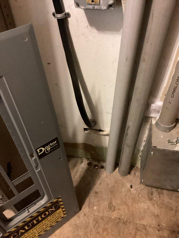 Verified and documented electrical service source for office space per landlord's request to confirm power origin. Inspected interior electrical panel labeled "Doctor" with associated conduit runs and exterior ground-level junction box with circuit protection devices. Photographically documented that office power is supplied from dedicated new service installation rather than museum electrical system, confirming independent electrical service to the office space.